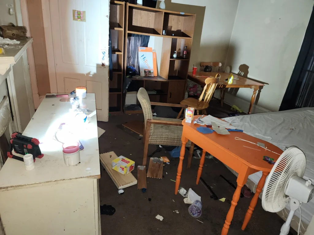 Before photo of a rental property cleanout in Lewisburg, TN with trash and debris before removal