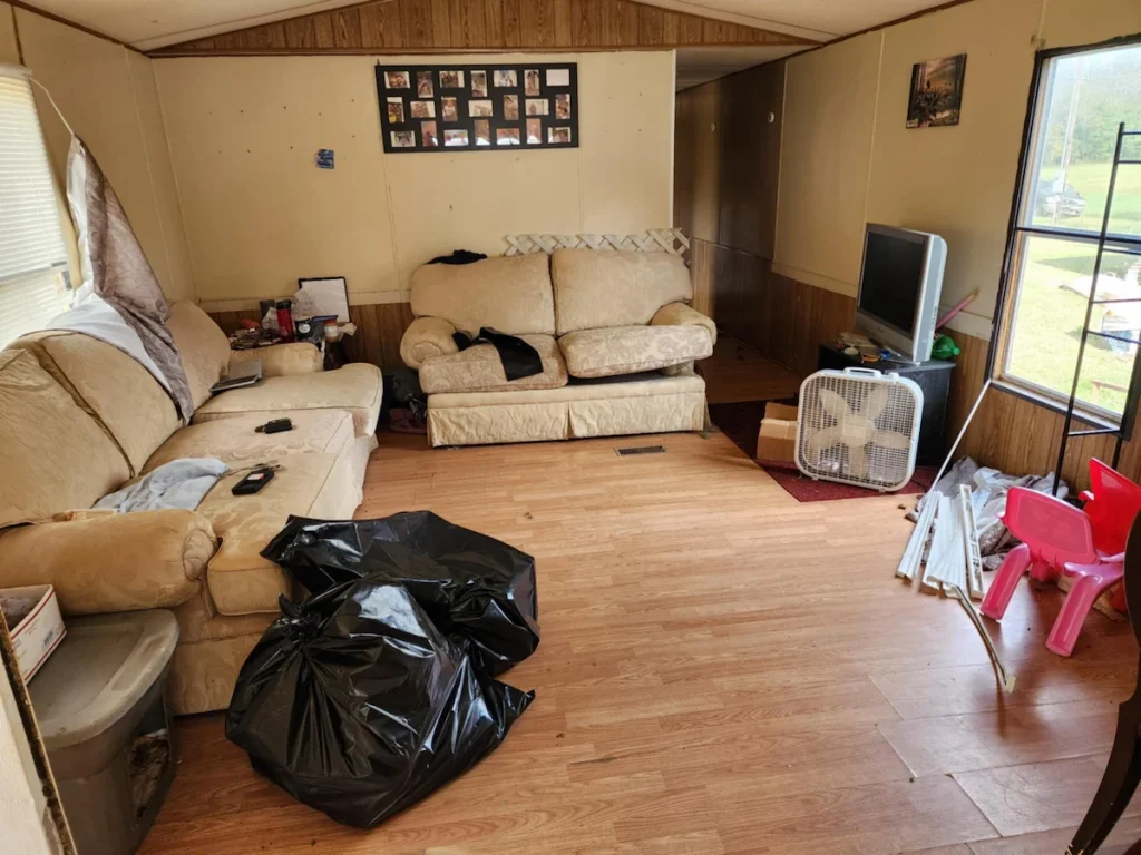 Before photo of a rental property living room cleanout in Tullahoma, TN